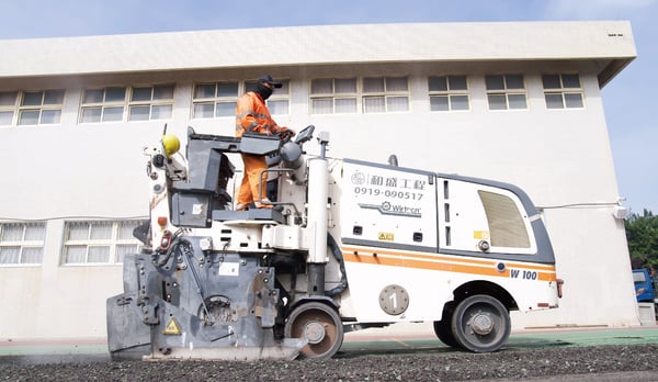 Operator milling asphalt road